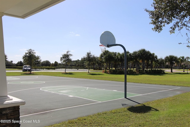 view of basketball court with community basketball court and a yard