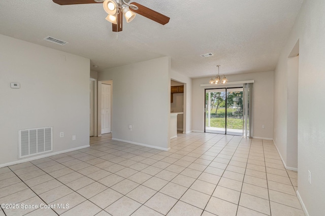257 Dorado Ave NE, Palm Bay, FL 32907 - unfurnished room featuring ceiling fan with notable chandelier, light tile patterned floors, and visible vents