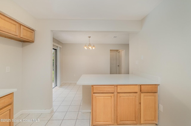 257 Dorado Ave NE, Palm Bay, FL 32907 - kitchen with light countertops, a chandelier, a peninsula, and light tile patterned flooring