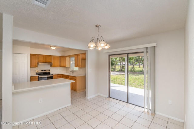 257 Dorado Ave NE, Palm Bay, FL 32907 - kitchen featuring visible vents, light countertops, a chandelier, under cabinet range hood, and electric range