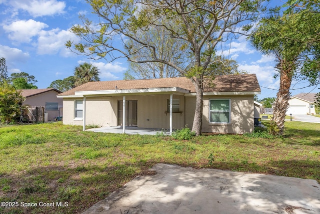 257 Dorado Ave NE, Palm Bay, FL 32907 - rear view of property with fence, a patio, a lawn, and stucco siding