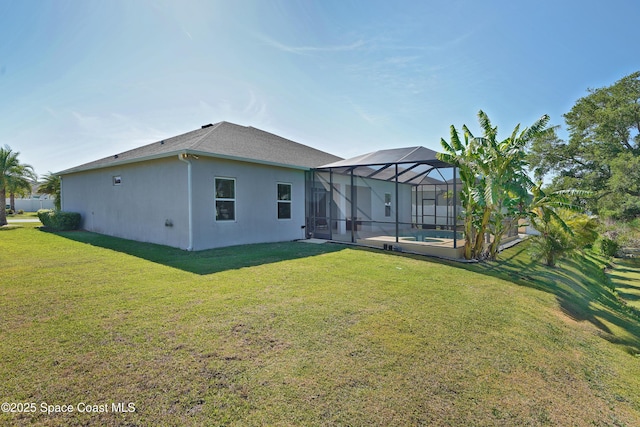 4710 Hebron Dr, Merritt Island, FL 32953 - back of property with an outdoor pool, a lawn, stucco siding, and glass enclosure