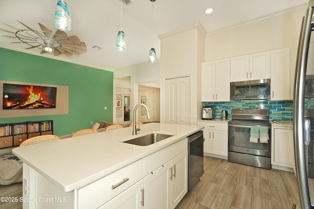 4710 Hebron Dr, Merritt Island, FL 32953 - kitchen with a ceiling fan, backsplash, crown molding, stainless steel appliances, and a sink