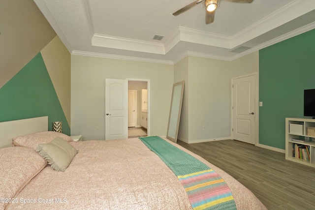 4710 Hebron Dr, Merritt Island, FL 32953 - bedroom with baseboards, ornamental molding, visible vents, a tray ceiling, and wood finished floors
