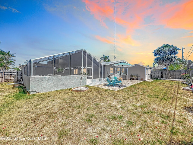 125 Terry St, Indian Harbour Beach, FL 32937 - back of property with a patio area, a fenced backyard, glass enclosure, and a yard