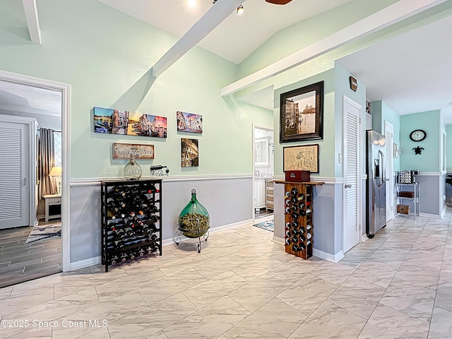 125 Terry St, Indian Harbour Beach, FL 32937 - bar featuring marble finish floor, stainless steel fridge with ice dispenser, lofted ceiling, and baseboards