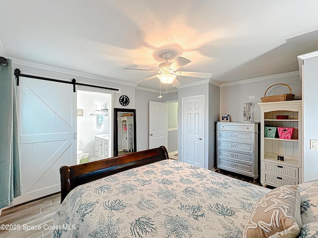 125 Terry St, Indian Harbour Beach, FL 32937 - bedroom with a barn door, wood finished floors, a ceiling fan, connected bathroom, and crown molding