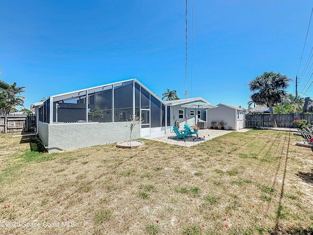 125 Terry St, Indian Harbour Beach, FL 32937 - rear view of property with a fenced backyard, a yard, and a patio area