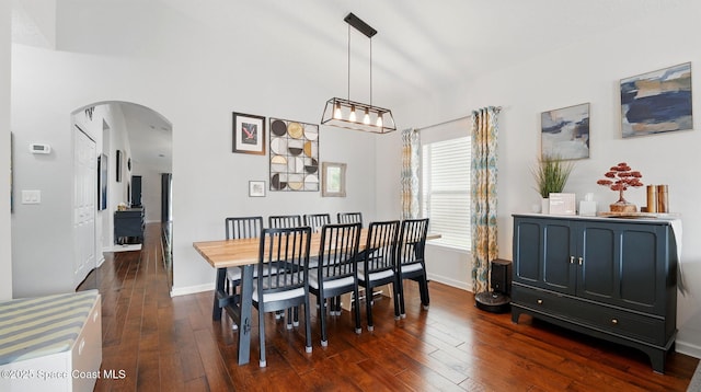 1546 Litchfield Dr, Melbourne, FL 32904 - dining area featuring arched walkways, baseboards, and dark wood finished floors