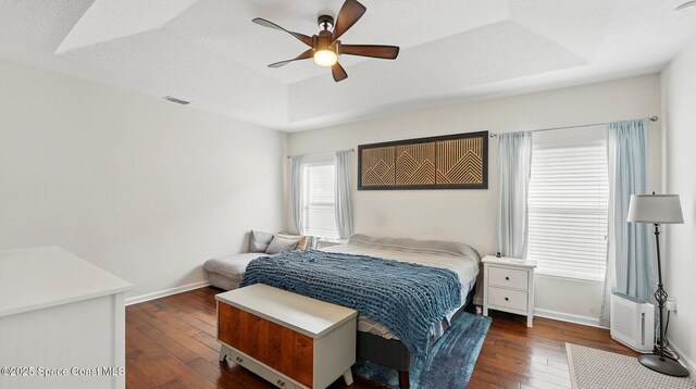 1546 Litchfield Dr, Melbourne, FL 32904 - bedroom with visible vents, a tray ceiling, baseboards, and dark wood finished floors