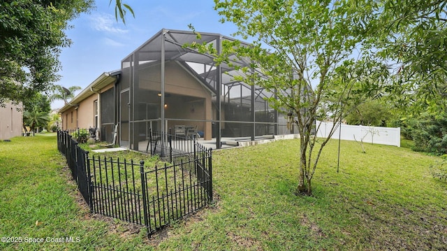 1546 Litchfield Dr, Melbourne, FL 32904 - rear view of property with a patio area, glass enclosure, fence, and a lawn