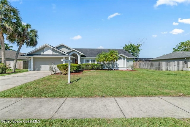 single story home with concrete driveway, a front lawn, fence, and an attached garage