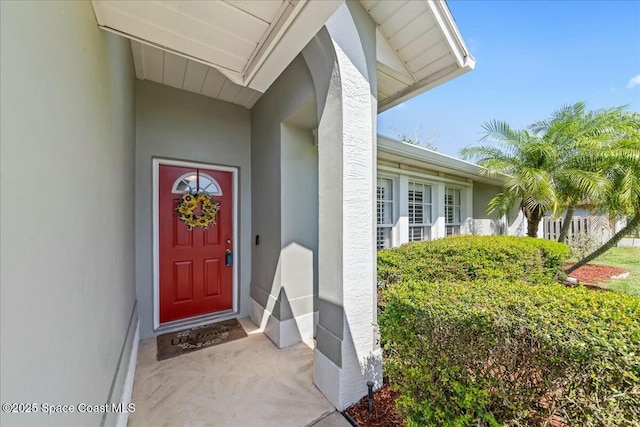 view of exterior entry featuring stucco siding