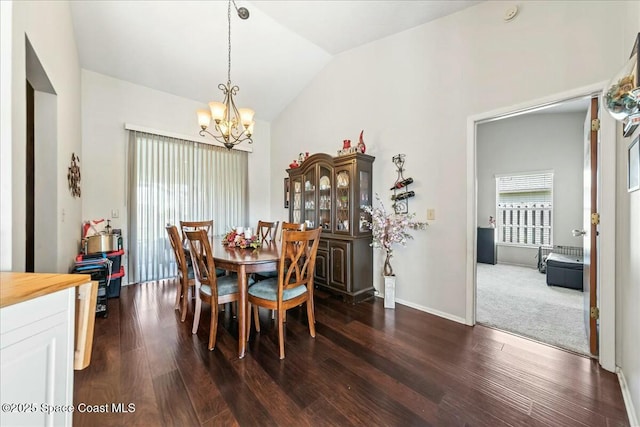 dining space featuring high vaulted ceiling, an inviting chandelier, baseboards, and dark wood-style floors