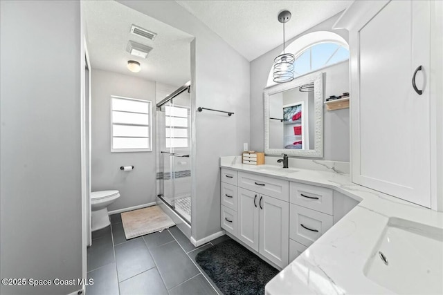 full bath featuring toilet, a stall shower, vanity, and a textured ceiling