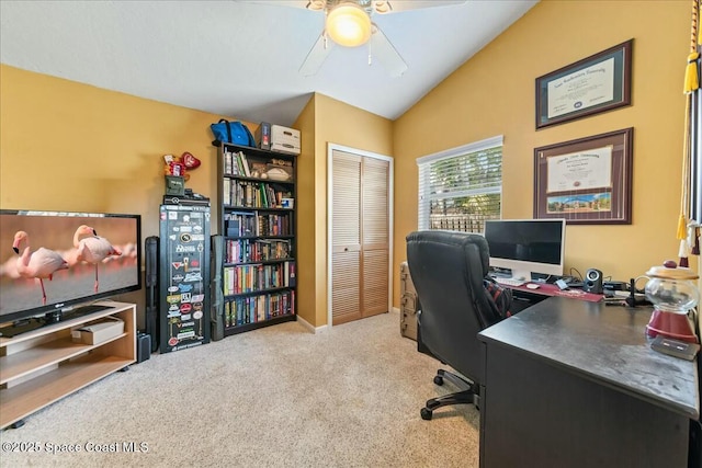 home office featuring carpet flooring, a ceiling fan, and lofted ceiling