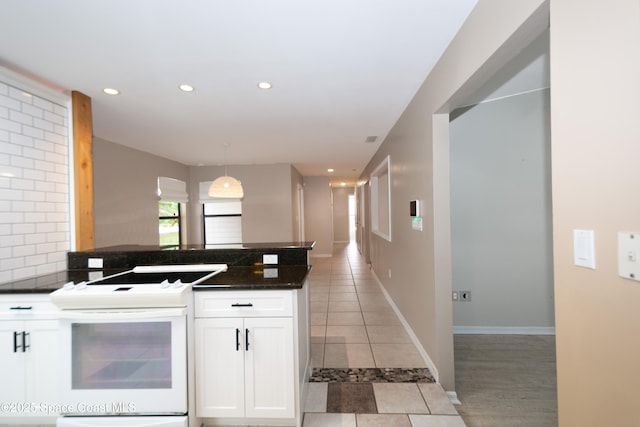 881 Brookson Ave NW, Palm Bay, FL 32907 - kitchen featuring white cabinets, recessed lighting, white range with electric stovetop, light tile patterned floors, and decorative backsplash