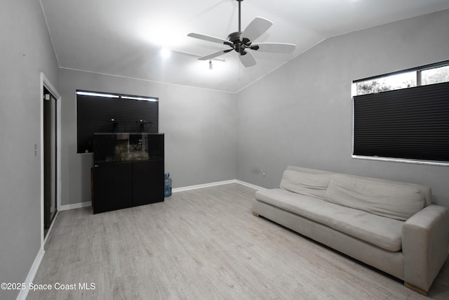 881 Brookson Ave NW, Palm Bay, FL 32907 - living room featuring lofted ceiling, baseboards, a ceiling fan, and wood finished floors