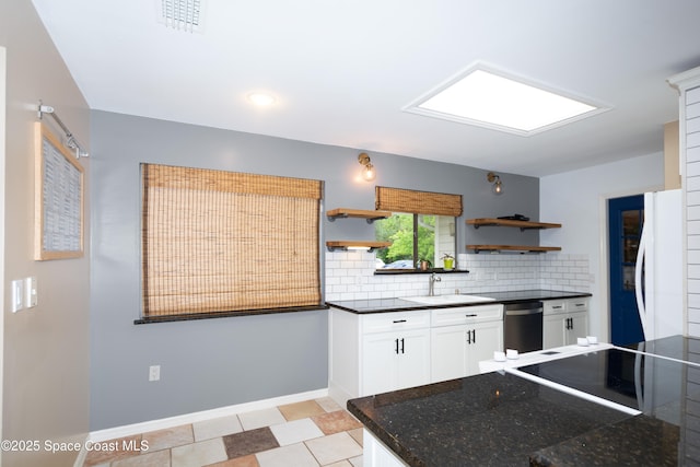 881 Brookson Ave NW, Palm Bay, FL 32907 - kitchen featuring open shelves, backsplash, white fridge, stainless steel dishwasher, and a sink