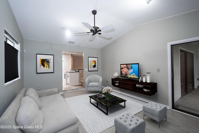 881 Brookson Ave NW, Palm Bay, FL 32907 - living area featuring vaulted ceiling, a ceiling fan, light wood-style floors, and visible vents