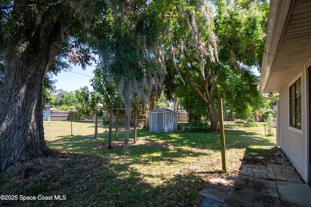 881 Brookson Ave NW, Palm Bay, FL 32907 - view of yard featuring a storage shed, a patio area, an outbuilding, and a fenced backyard