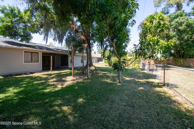 881 Brookson Ave NW, Palm Bay, FL 32907 - view of yard with a fenced backyard and a sunroom