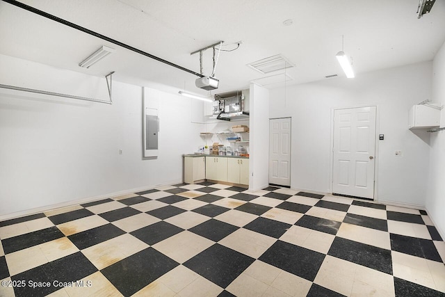 garage with electric panel and a garage door opener