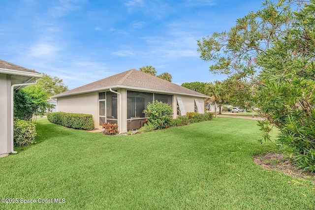 view of property exterior featuring stucco siding, a sunroom, and a lawn