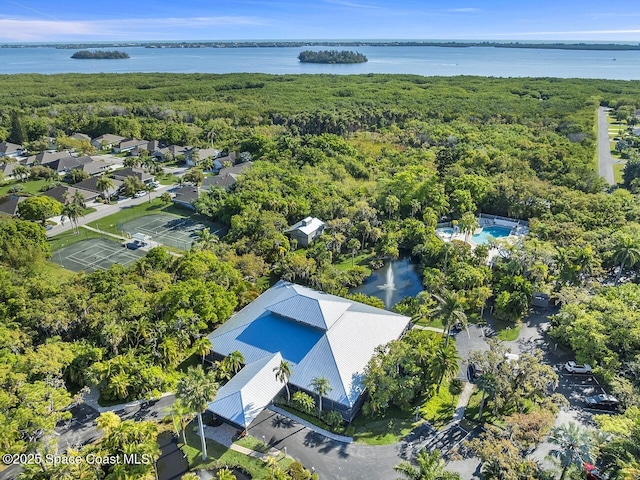 birds eye view of property featuring a water view and a forest view