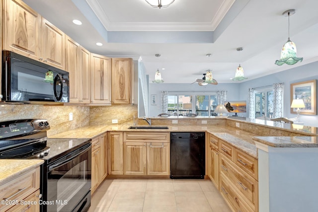 2470 Harbour Cove Dr, Hutchinson Island, FL 34949 - kitchen featuring crown molding, a tray ceiling, black appliances, and light brown cabinetry