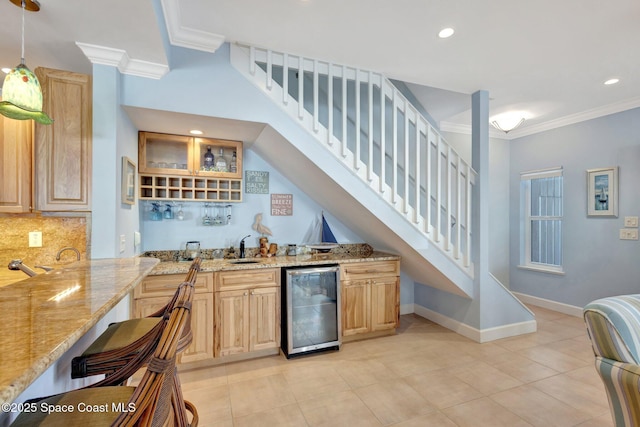 2470 Harbour Cove Dr, Hutchinson Island, FL 34949 - bar with baseboards, indoor wet bar, ornamental molding, backsplash, and beverage cooler