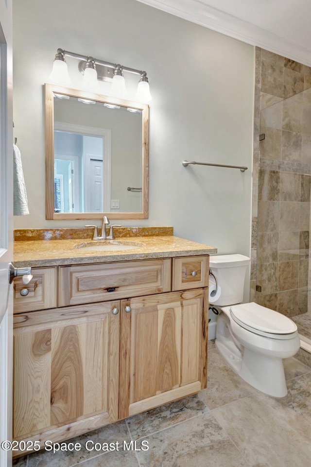 2470 Harbour Cove Dr, Hutchinson Island, FL 34949 - full bathroom featuring toilet, vanity, a tile shower, and ornamental molding