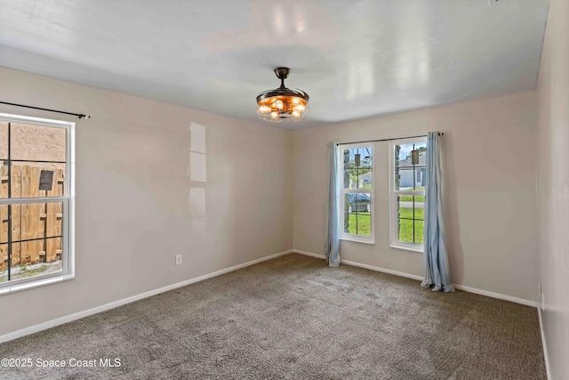 unfurnished room featuring carpet flooring and baseboards