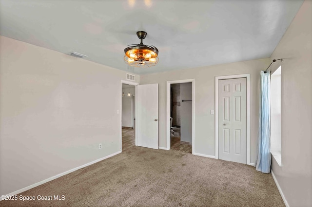 unfurnished bedroom with baseboards, visible vents, and carpet floors