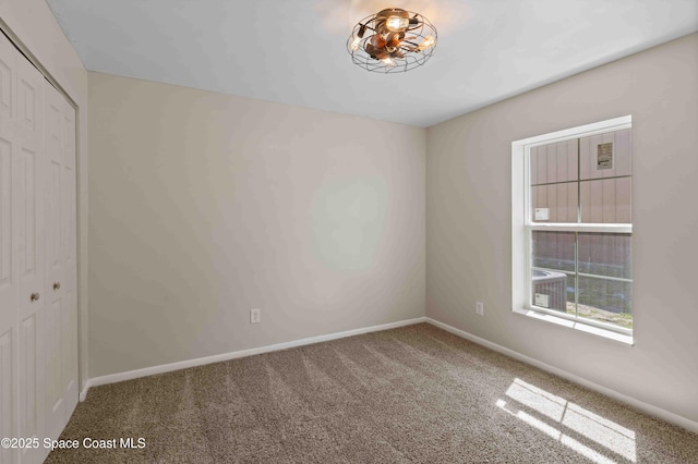 spare room with carpet flooring and baseboards