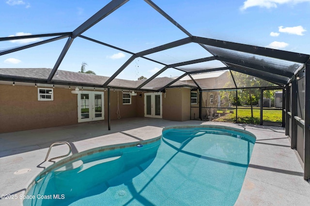 pool with a patio area, french doors, and glass enclosure