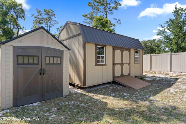 view of shed with fence