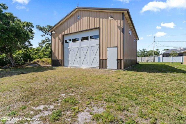 detached garage featuring fence