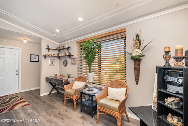 sitting room with crown molding, recessed lighting, baseboards, and wood finished floors