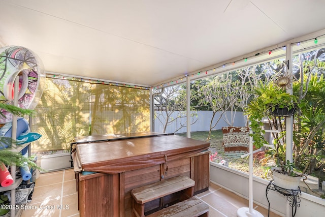 sunroom / solarium with tile patterned floors and a hot tub