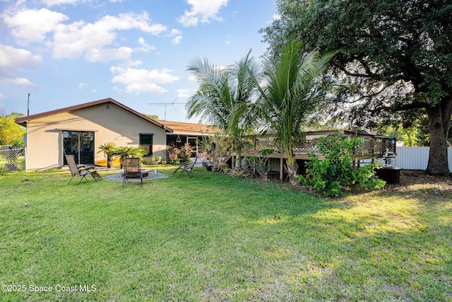 view of yard featuring a fire pit and fence