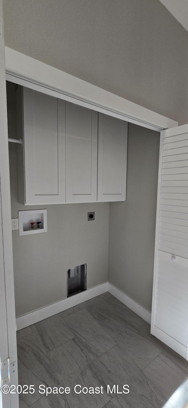 laundry room with hookup for an electric dryer, baseboards, hookup for a washing machine, and cabinet space