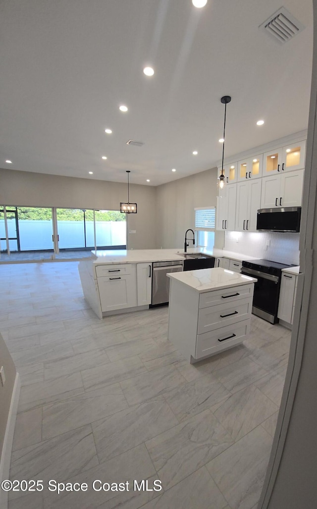 kitchen with a healthy amount of sunlight, visible vents, marble finish floor, and appliances with stainless steel finishes