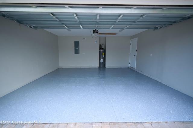 garage featuring electric panel, water heater, and a garage door opener