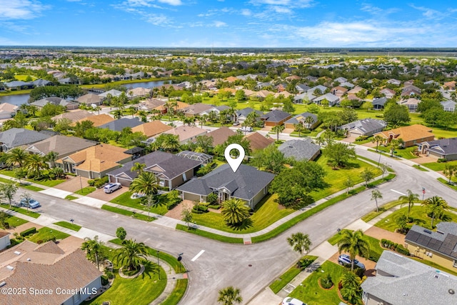drone / aerial view featuring a residential view and a water view