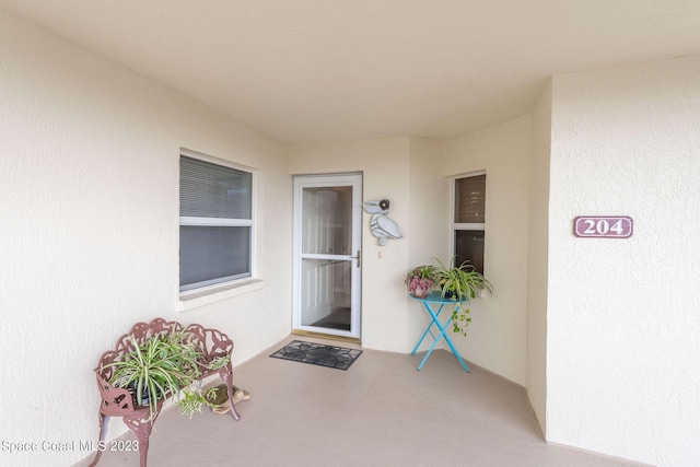 8941 Lake Dr Unit 204, Cape Canaveral, FL 32920 - doorway to property featuring stucco siding