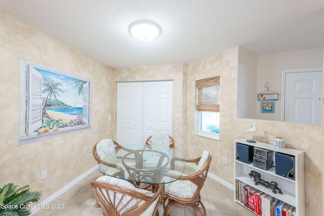 8941 Lake Dr Unit 204, Cape Canaveral, FL 32920 - dining space featuring light tile patterned floors, baseboards, and a textured ceiling