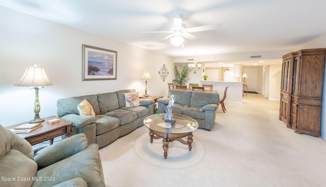 8941 Lake Dr Unit 204, Cape Canaveral, FL 32920 - living room featuring visible vents, light colored carpet, and ceiling fan with notable chandelier
