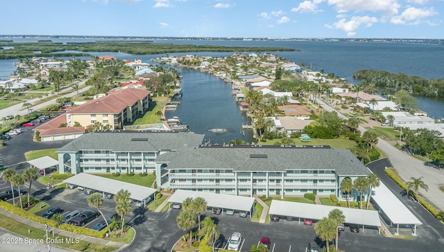 birds eye view of property with a water view and a residential view