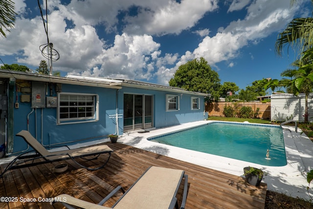 view of pool featuring fence, a fenced in pool, and a wooden deck